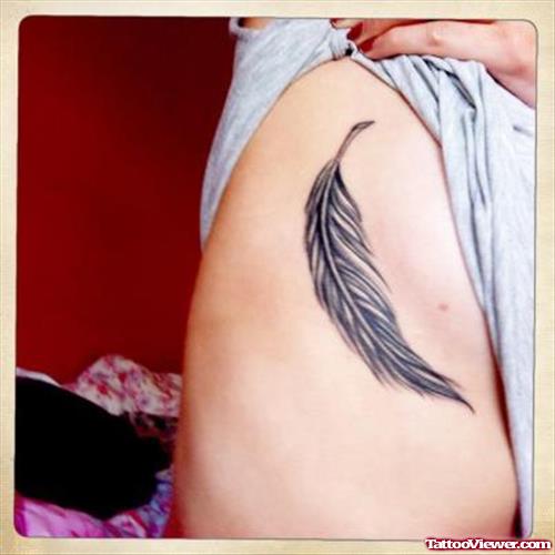 Beautiful Grey Ink Feather Tattoo On Rib