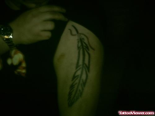 Awesome Left Bicep Feather Tattoo