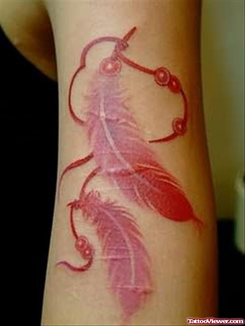 Pink Feather Tattoo On Bicep