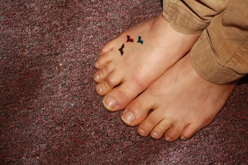 Color Flying Birds And Feet Tattoo