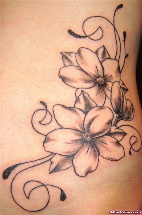 Grey Ink Flowers Feminine Tattoo On Side Rib