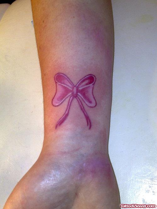 Feminine Pink Bow Tattoo On Wrist