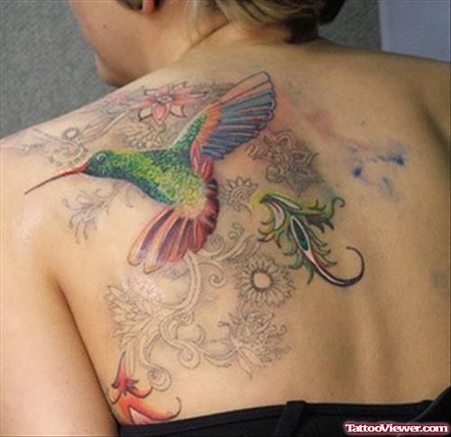 Flowers And Colored Hummingbird Feminine Tattoo On Back