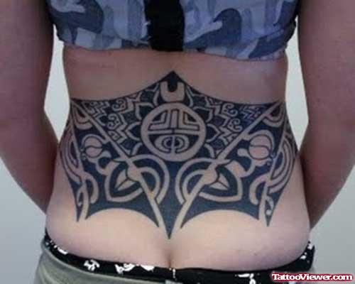 Black Ink Tribal Feminine Tattoo On Lowerback