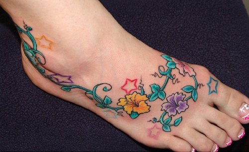 Attractive Colored Flowers Feminine Tattoo On Foot