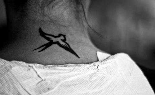Flying Feminine Bird Tattoo On Nape