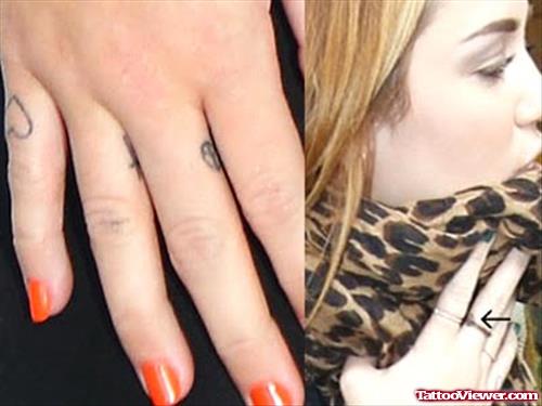 Miley Cyrus With Heart Finger Tattoo