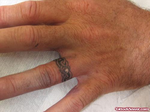 Black Ink Celtic Finger Tattoo