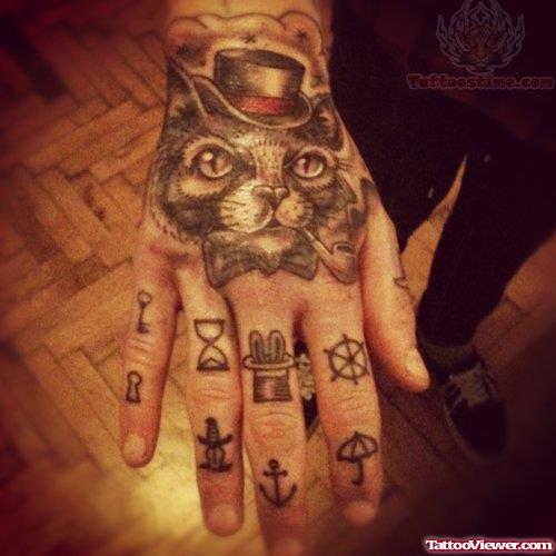 Cat With Hat And Hourglass Tattoo On Finger
