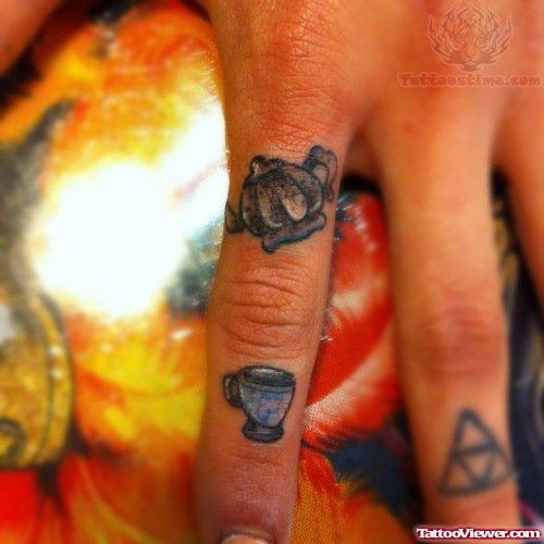 Cattle And Cup Tattoo On Finger