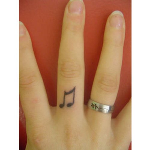 Black Ink Music Note Finger Tattoo