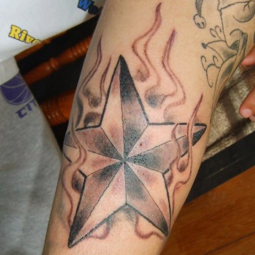 Flaming Nautical Star Tattoo On Sleeve