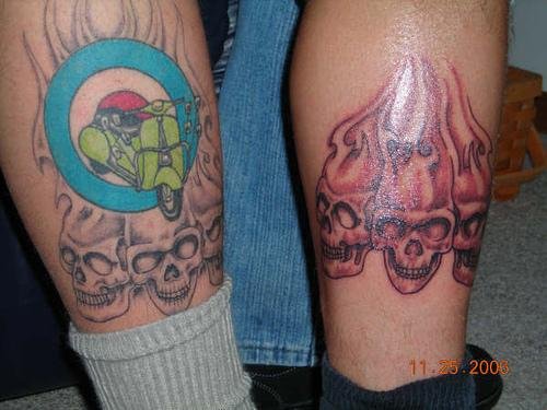 Grey Ink Flaming Skulls Tattoos On Legs