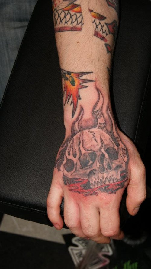 Grey Ink Skull With Flames Tattoo On Hand