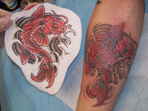 Red Ink Fish Tattoo On Design For Arm