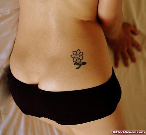 Small Flower Tattoo On Girl Lowerback