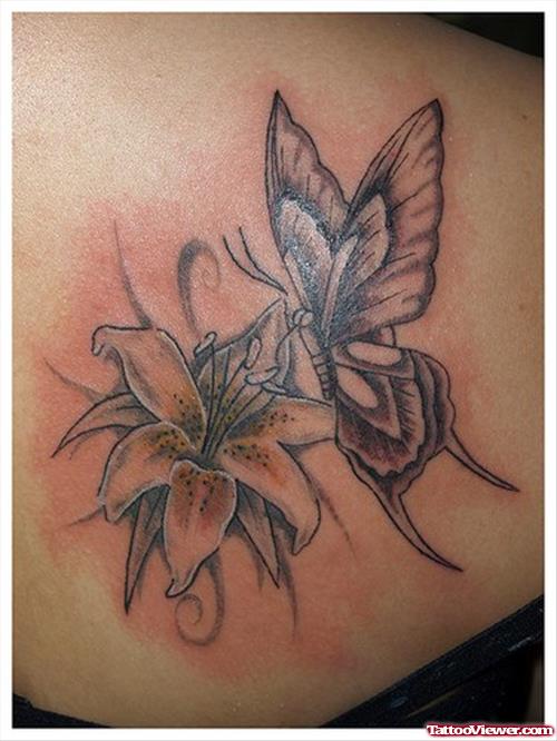 Grey Ink Lily Flower And Butterfly Tattoo On Back