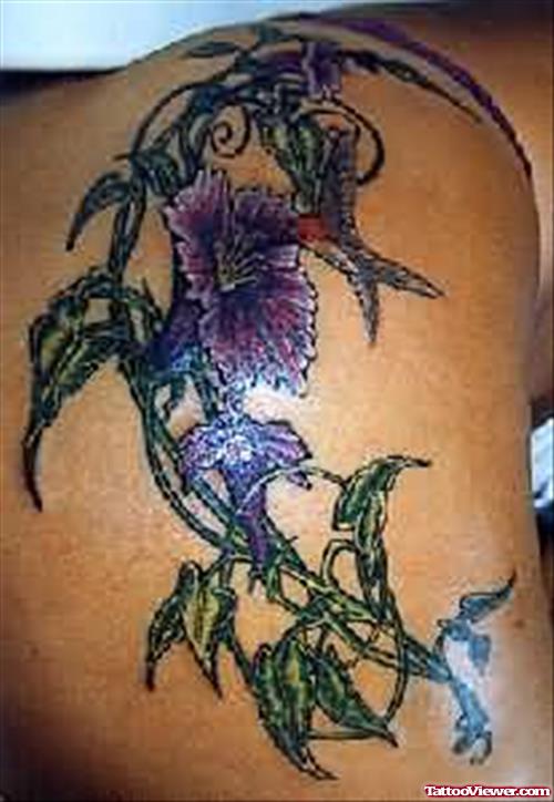 Man Showing Flower Tattoo On Biceps