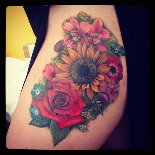 Colored Flowers Tattoo On Bicep