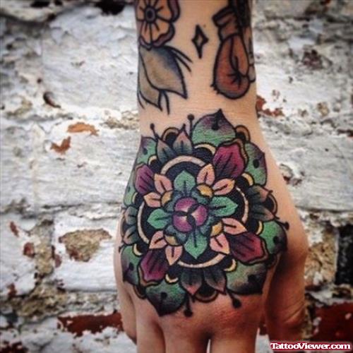 beautiful colored flower tattoo on hand