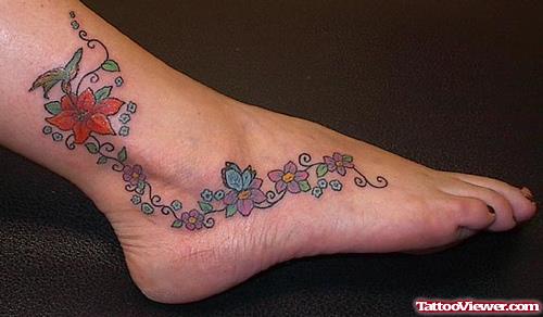Awesome Colored Flowers Foot Tattoo