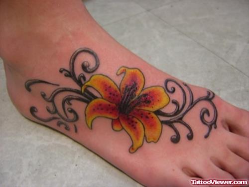 Tribal And Lily Flower Foot Tattoo