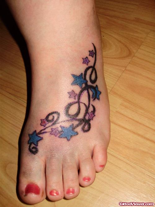 Colored Stars And Tribal Foot Tattoo