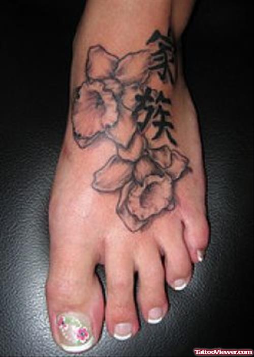 Grey Ink Flowers And Chinese Symbols Foot Tattoo