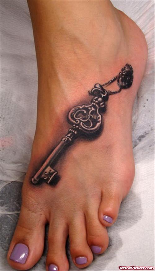 Grey Ink 3D Key Tattoo On Left Foot