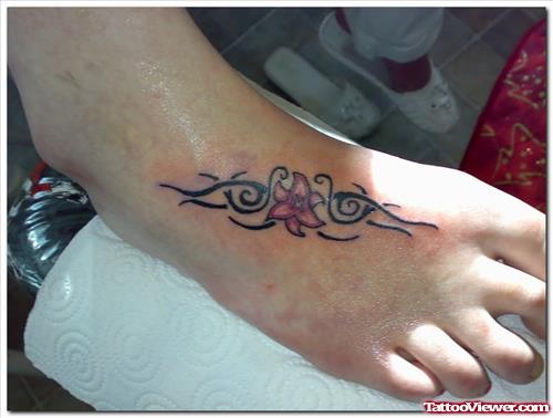 Black Ink Tribal And Red Flower Foot Tattoo