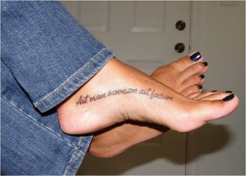 Girl With Lettering Tattoo On Left Foot