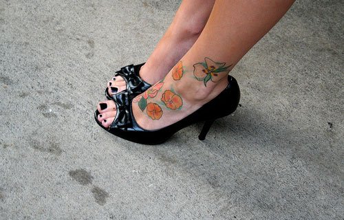 Colored Flowers Tattoos On Girl Left Foot