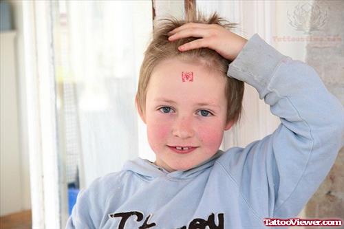 Bulb Tattoo On Child Forehead