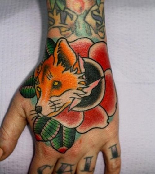 Red Flower And Fox Head Tattoo On Left Foot