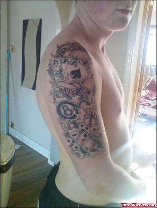 Grey Ink Flaming Cards And Eightball Gambling Tattoo On Man Right Half Sleeve