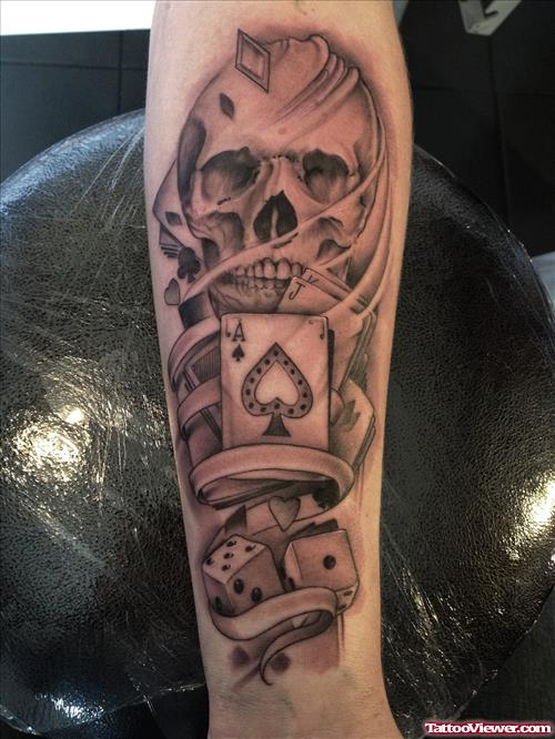 Grey Ink Skull And Cards Gambling Tattoo On Arm