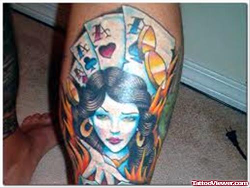 Girl Head And Flaming Cards Gambling Tattoo On Back Leg