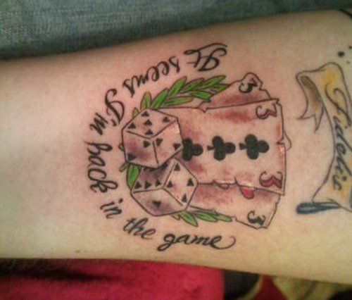 Grey Ink Cards And Dice Gambling Tattoo On Sleeve