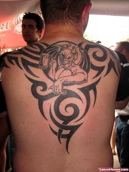 Tribal And Gargoyle Tattoo On Man Upperback