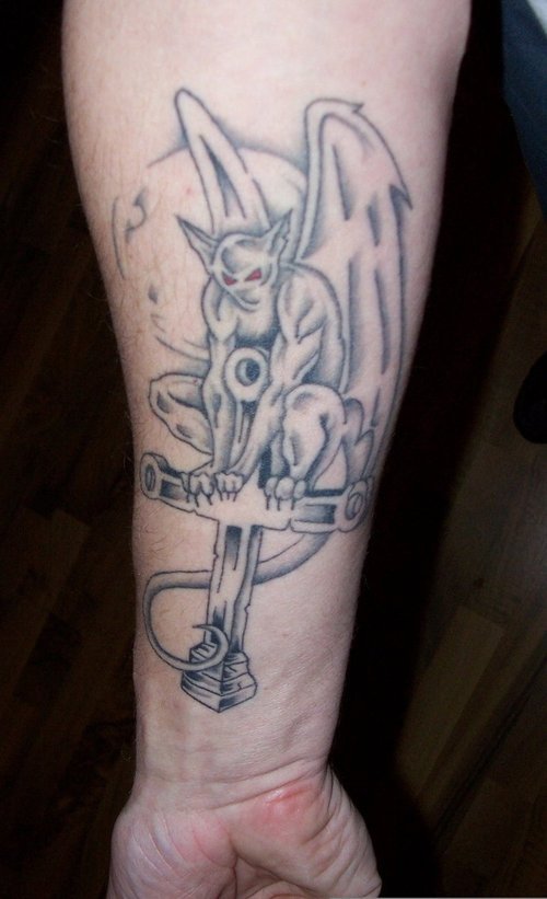 Cross And Gargoyle Tattoo On Forearm