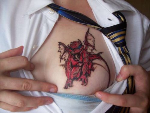 Red Ink Gargoyle Tattoo On Man Chest