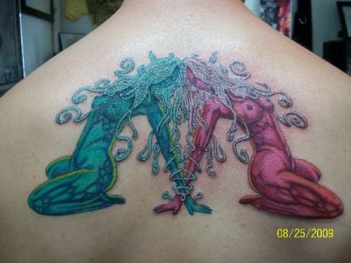 Colored Gemini Tattoo On Upperback
