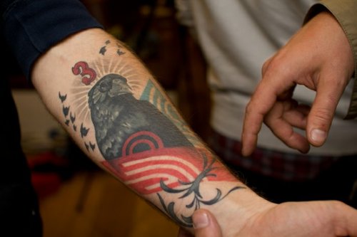 Grey Ink Bird And Geometric Tattoo On Forearm