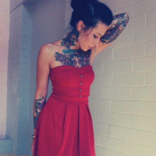 Girl With Traditional Tattoos On Sleeve And Chest