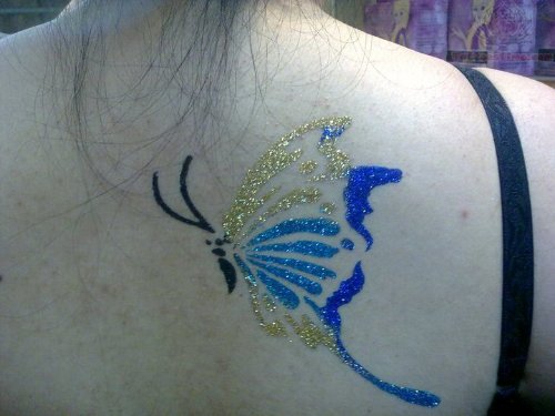 Glitter Butterfly Tattoo On Girl Upperback