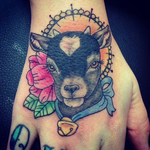 Red flower And Goat Head Tattoo On Right Hand