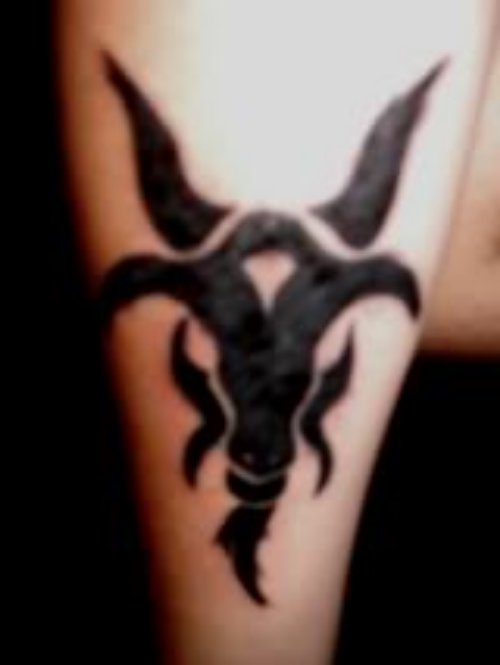 Black Ink Tribal Goat Tattoo On Bicep