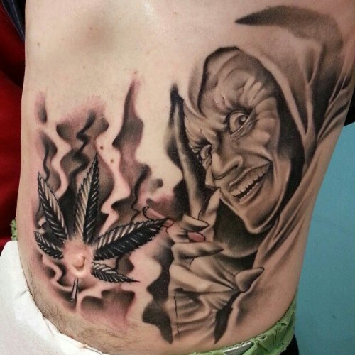Marijuana Leaf And Goblin Tattoo On Back Body