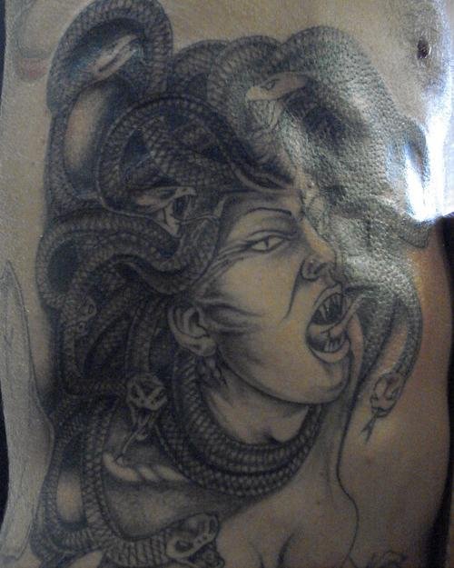 Grey Ink Gothic Head Tattoo On Belly