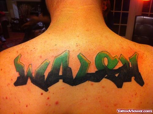 Black And Green Ink Graffiti Tattoo On Upperback